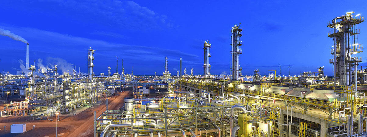 an oil refinery lit up at night time